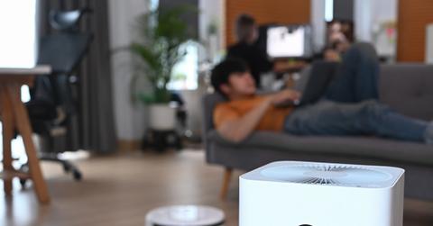 air purifier in a living room with man in background