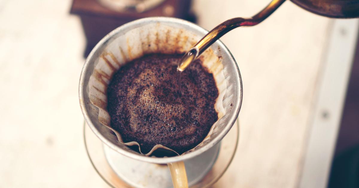 Hot water being poured over fresh coffee grounds