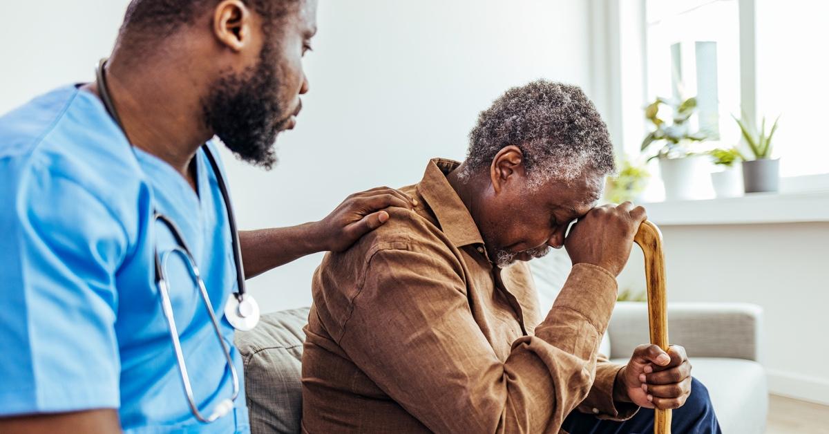 Elderly patient speaking with his doctor. 