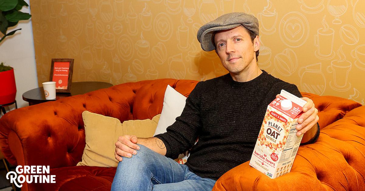 Jason Mraz sits on a couch holding a Planet Oat Barista Lovers carton at a Planet Oat pop-up event at Chelsea Market in New York City, on Jan. 25, 2024.