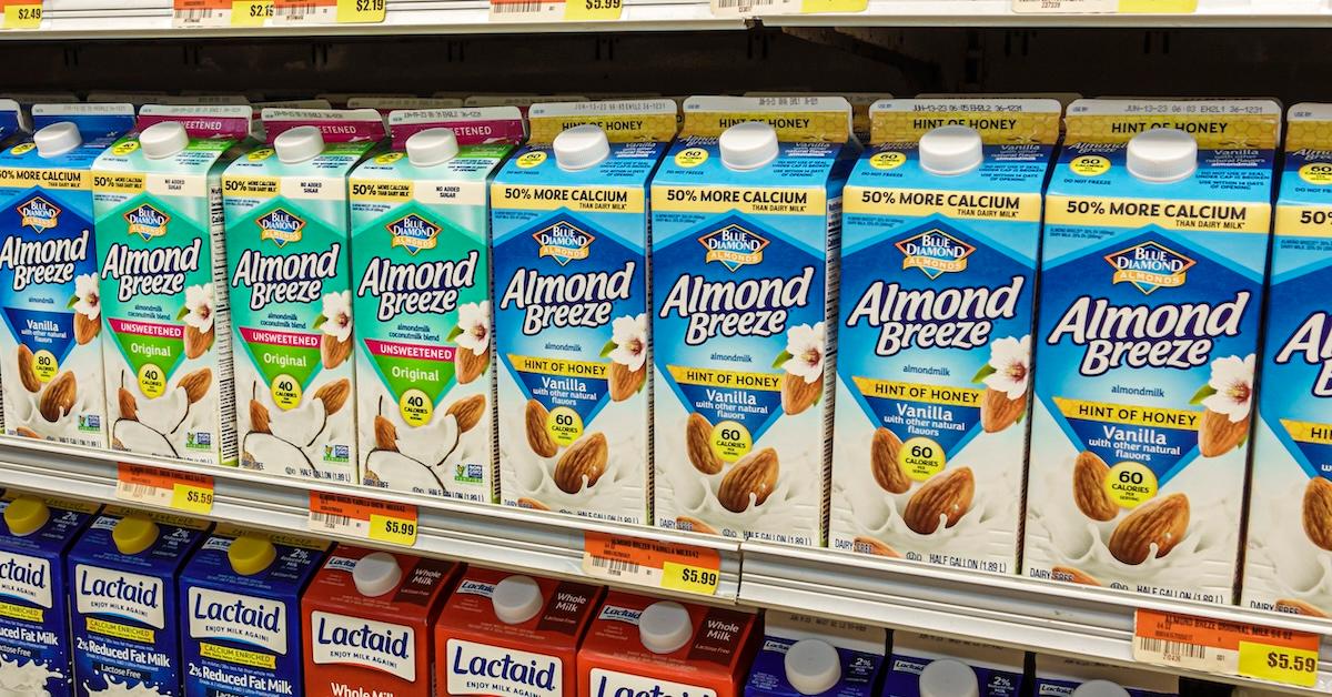 Bottles of Almond Breeze milk in varying varieties on a supermarket shelf