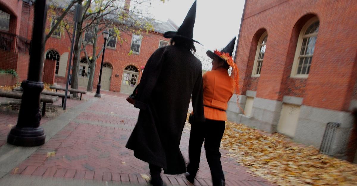 Two people dressed as witches walking in Salem, MA.