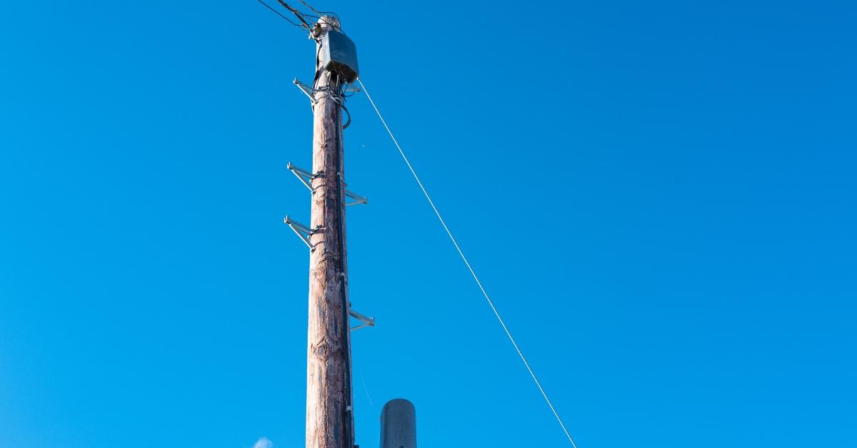 Telephone pole with power lines during the day. 