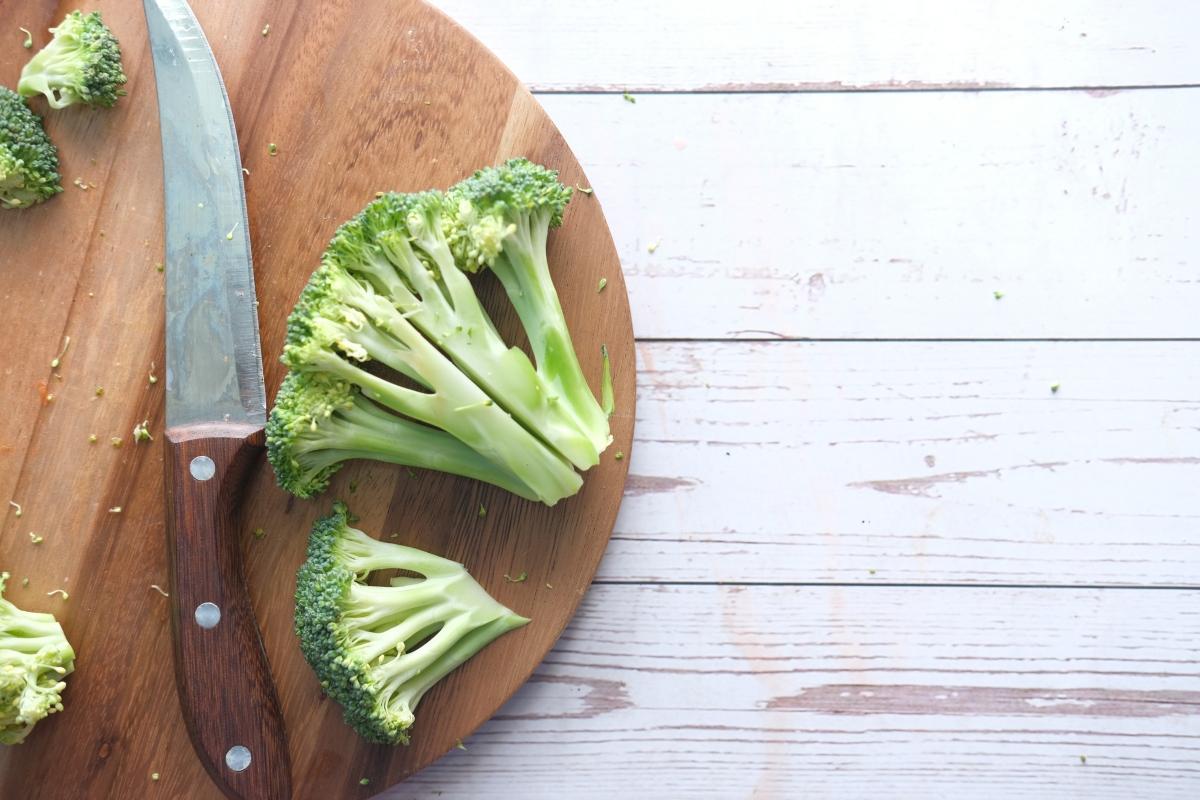 broccoli on cutting board with knife