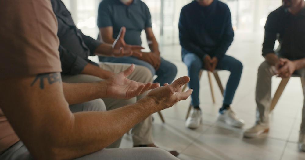 Men in group therapy session.