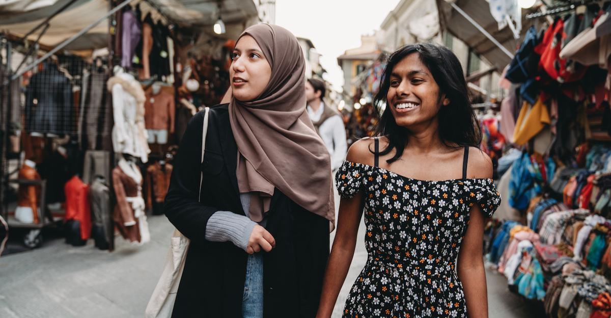 Two friends shopping at a flea market.