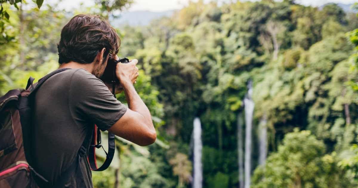 A photographer focusing on capturing a stunning shot of a rainforest. (Representative Image Source: Getty Images | Jacoblund)