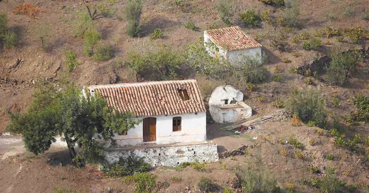 A house surrounded by dry soil.