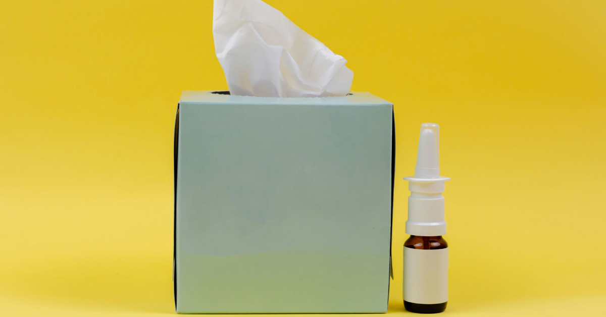 A tissue box sits next to a nasal spray can