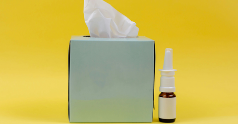 A tissue box sits next to a nasal spray can