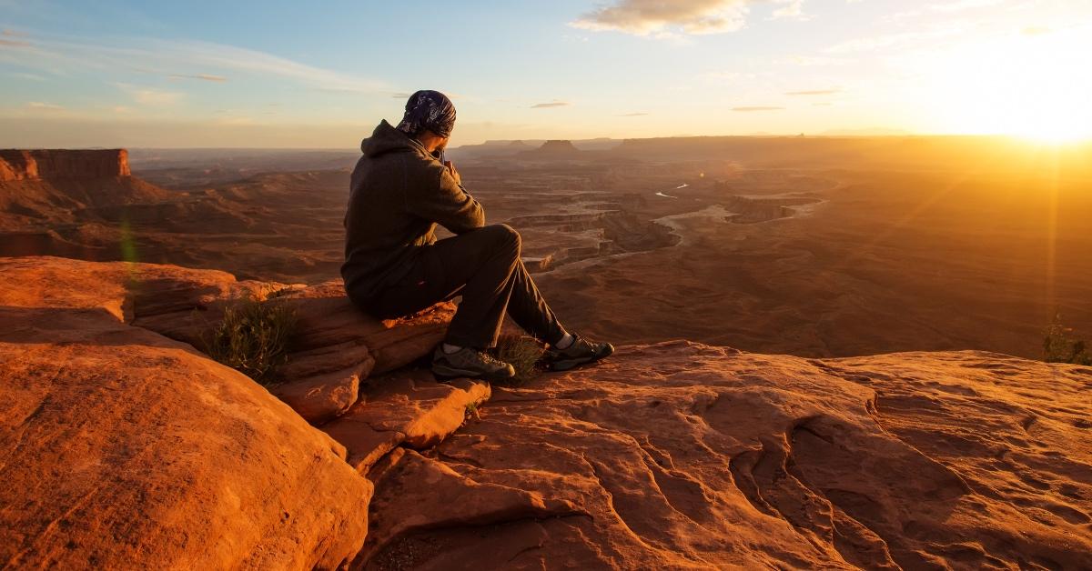 Stock photograph of a hiker overlooking the Grand Canyon.