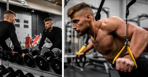 Two male athletes perform weight exercises in a gym.