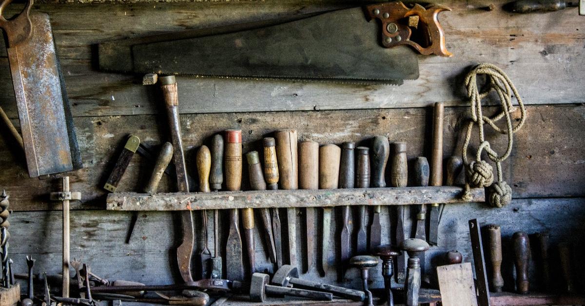 Carving tools in a wooden shed lined up in a row. 