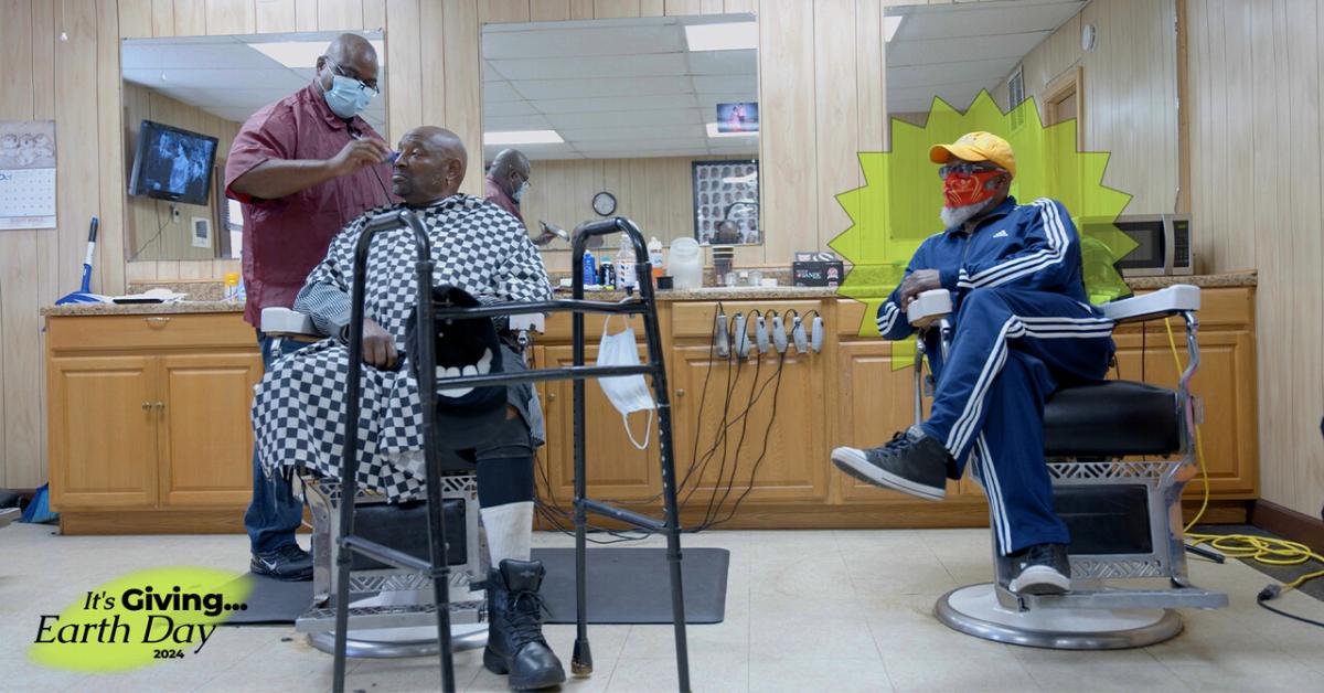 Still from Resita Cox's documentary 'Freedom Hill' featuring three men in a barber shop with Green Matters's Earth Day logo layered on top