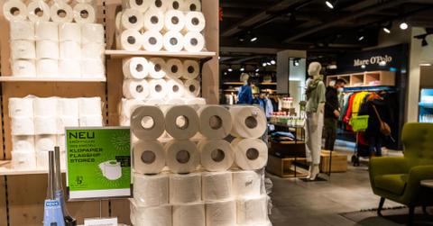 Toilet paper and fashion items are on display on the shelves and the sales floor at the Blum-Jundt fashion store.