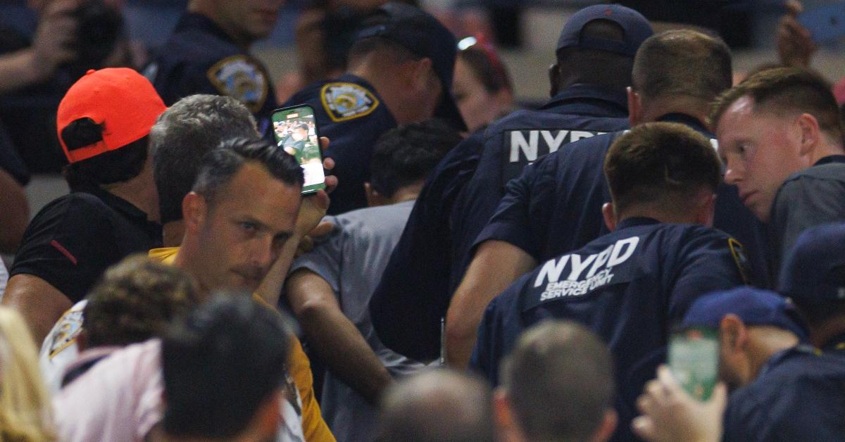 A climate activist is arrested by NYPD at the US Open. 