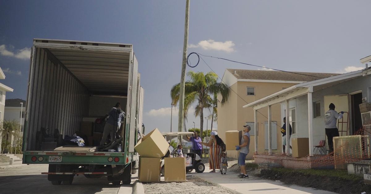 Photo fo family moving boxes into a moving van in Miami's Liberty Square neighborhood