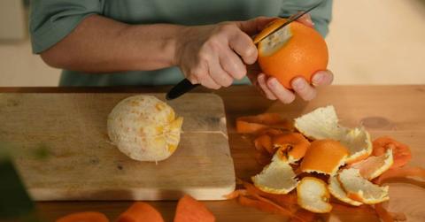 A woman peeling an orange (Representative Cover Image Source: Getty Images | Ekaterina Vasileva-Bagler)