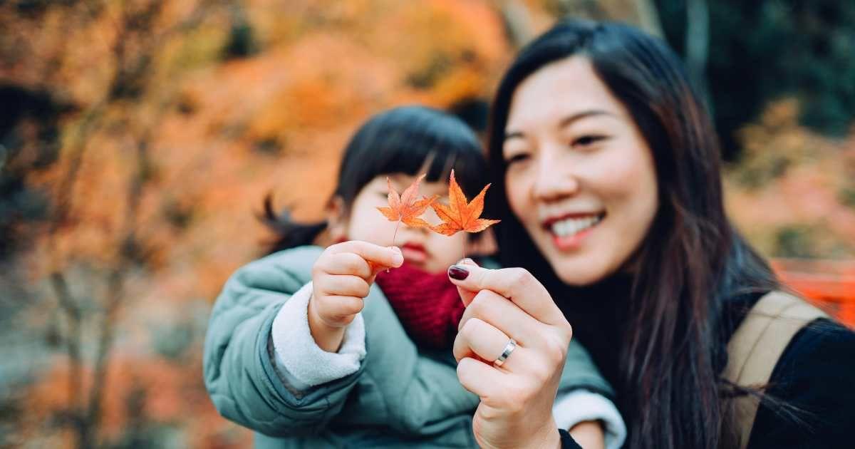 A young mother and her adorable little daughter are holding a fallen red maple leaf together. (Representative Cover Image Source: Getty Images | d3sign)