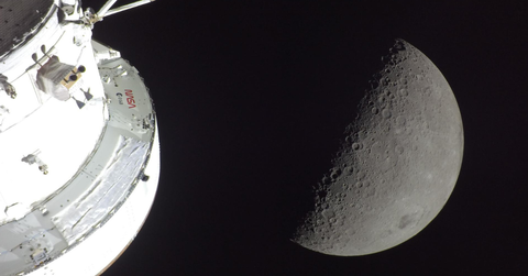 The side of a ship and the moon as seen from Artemis II mission