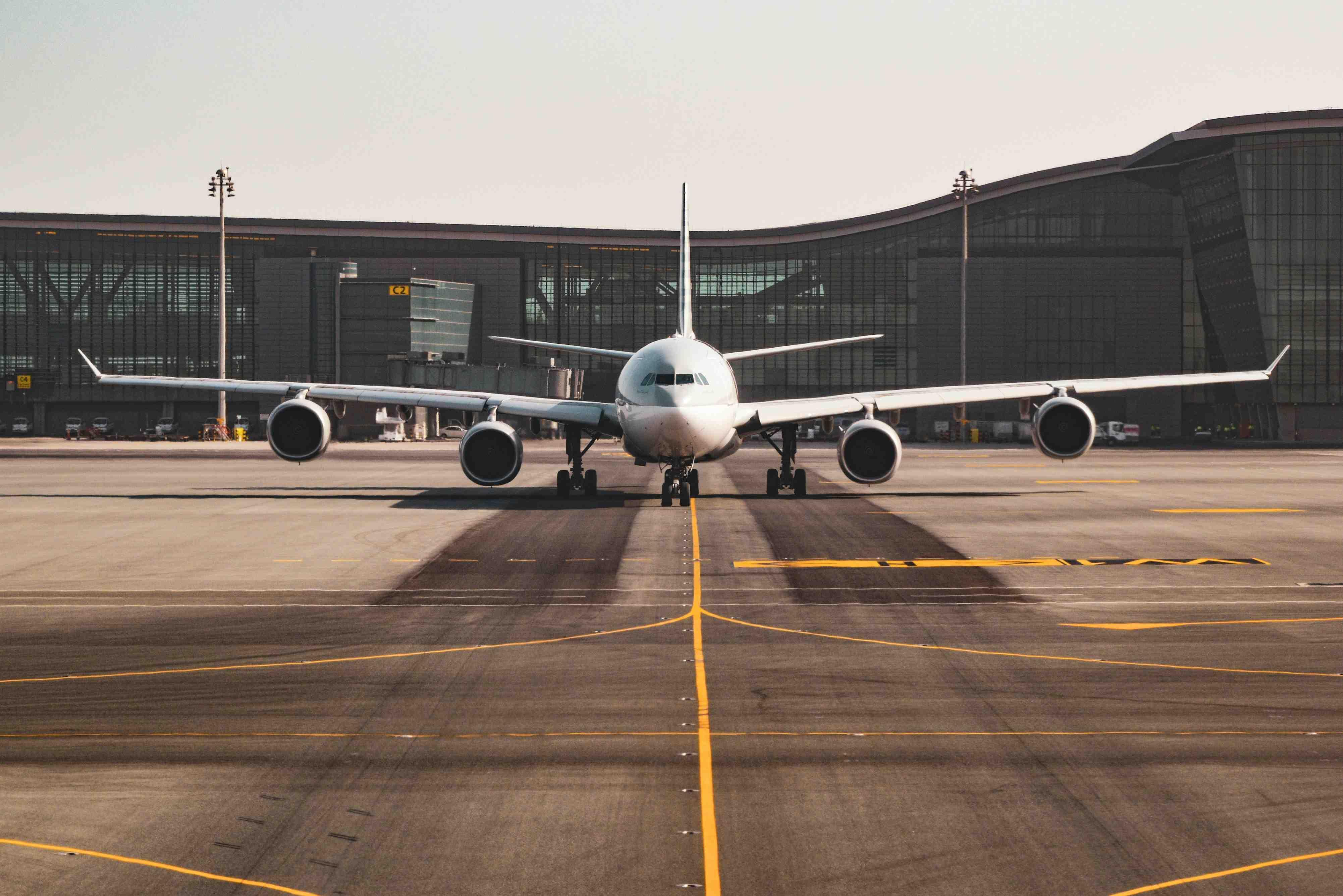 A plane is pictured grounded at an airport on the runway.
