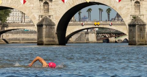 A local resident swims in the Seine, in Paris on July 17, 2024, after the mayor of Paris swam in the river to demonstrate that it is clean enough to host the outdoor swimming events at the Paris Olympics.