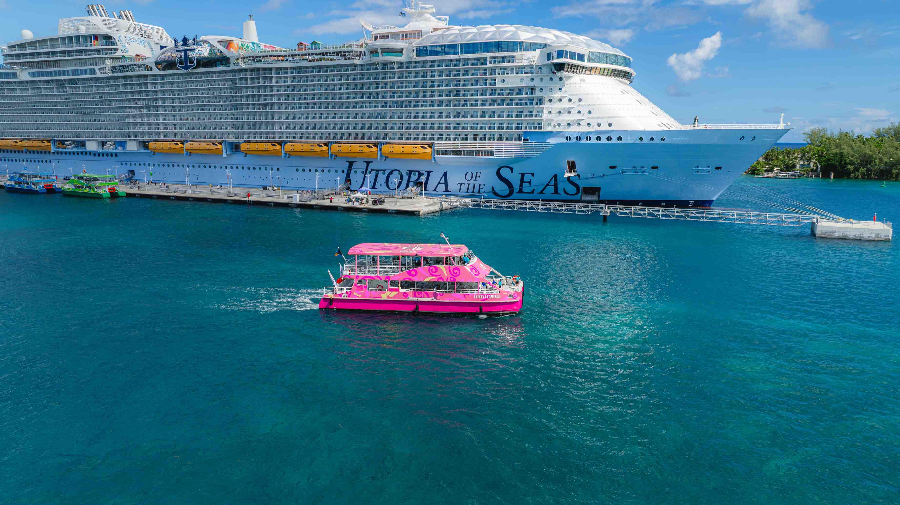 A Royal Caribbean water ferry is pictured next to the Utopia of the Seas cruise ship.