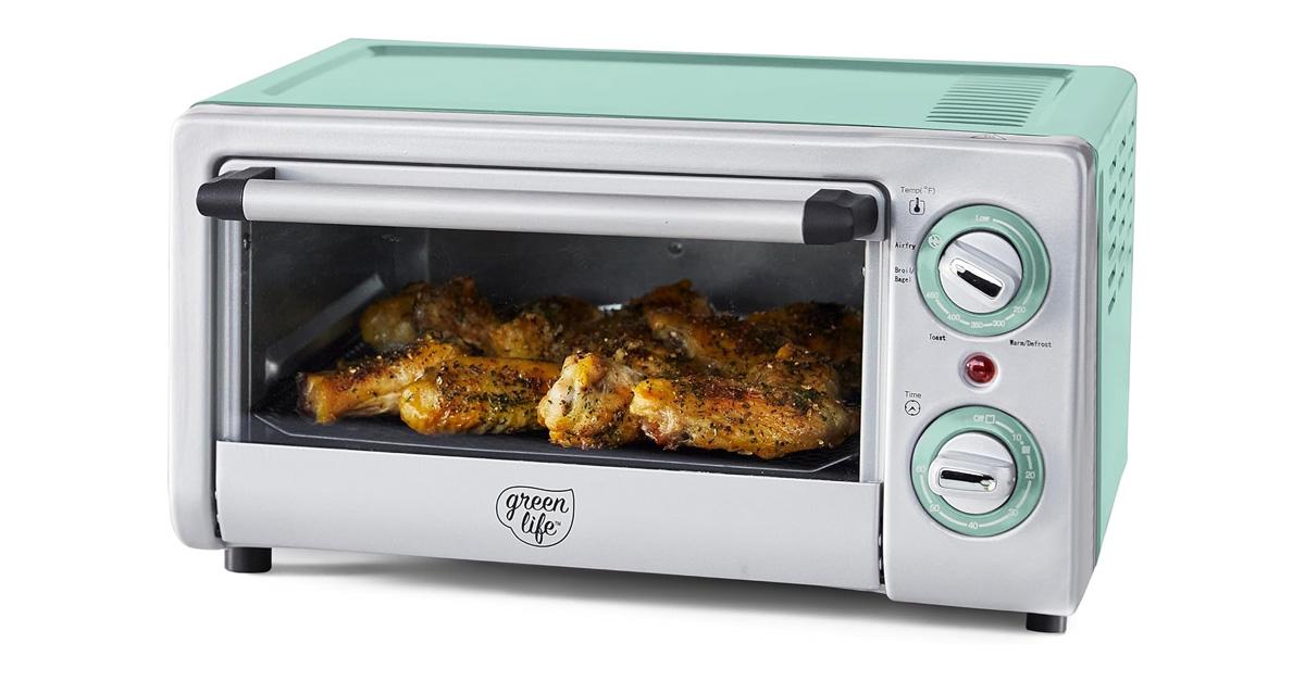 Mint green and stainless air fryer oven with chicken inside