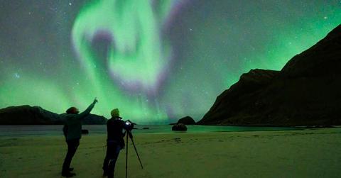 Two people looking at the Northern Lights. (Representative Cover Image Source: Getty Images | Roberto Moiola)