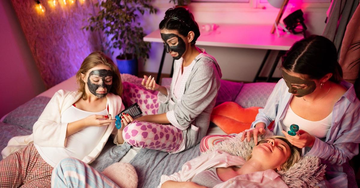 Four teen girls applying skincare at a sleepover. 