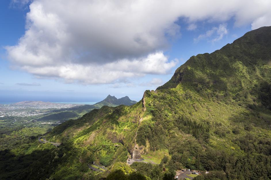 A photo taken from a high angle of the sun on the side of a mountain in Oahu. 