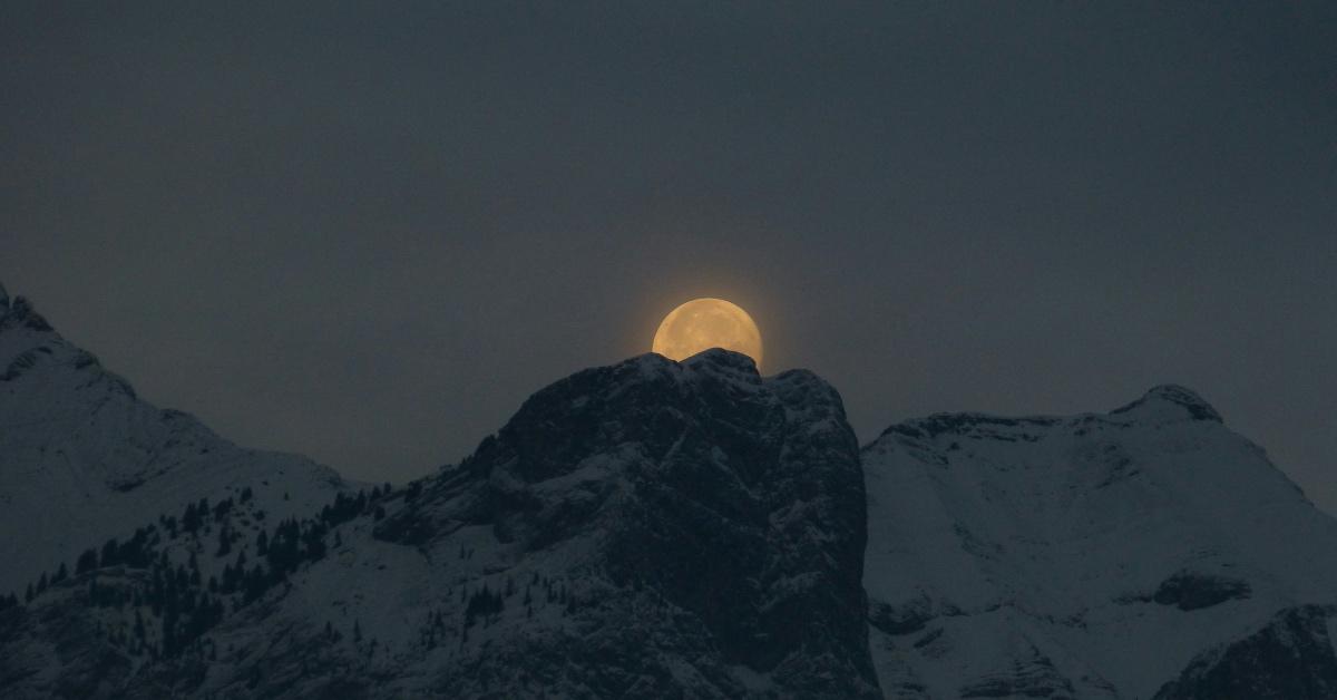 Beaver Moon visible over the ridge of a mountain