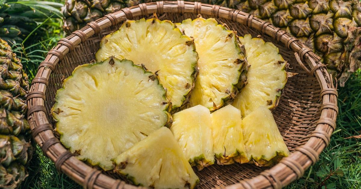 Photograph of sliced pineapple in a basket.