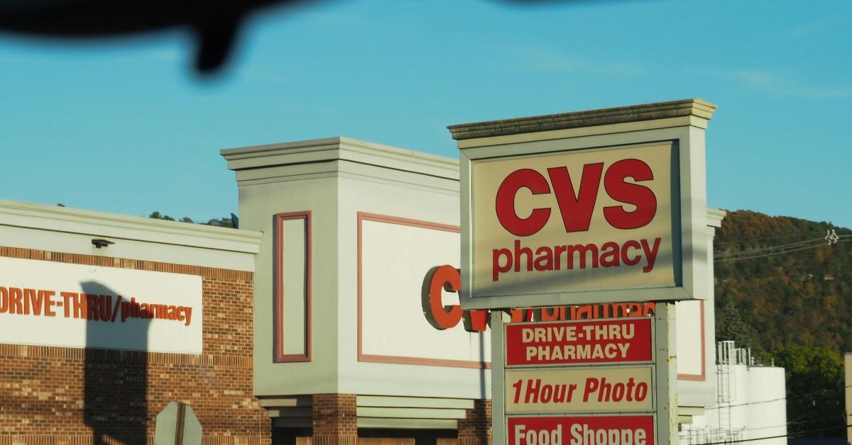 A CVS storefront is visible through a car windshield 