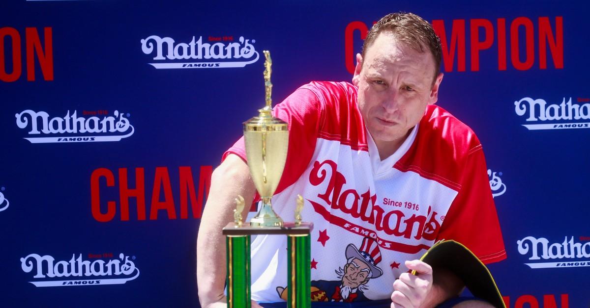 Joey Chestnut poses with a trophy after winning the 2022 hot dog eating contest 