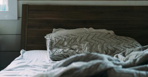 Closeup of a pillow on an unmade bed