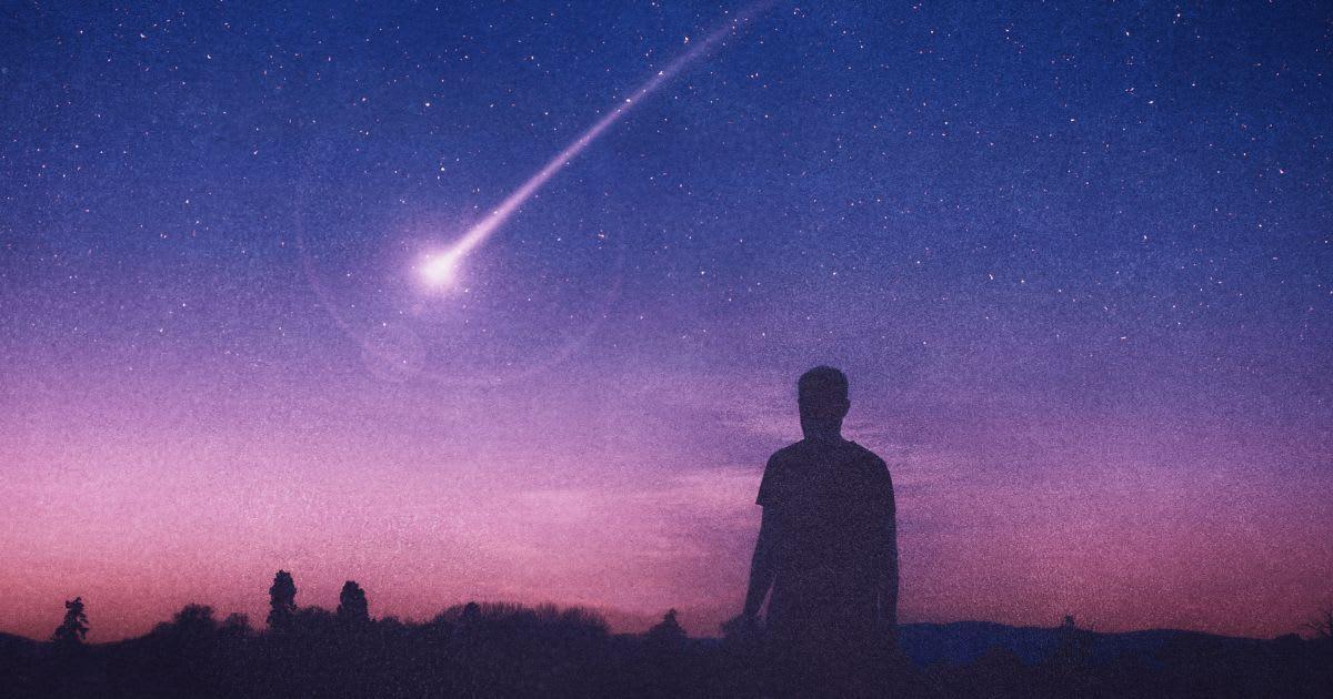A man gazing at a comet in the night sky (Representative Cover Image Source: Getty Images | Davis Wall)