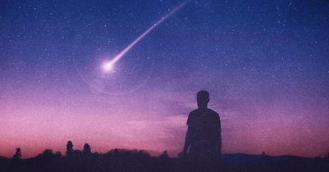 A man gazing at a comet in the night sky (Representative Cover Image Source: Getty Images | Davis Wall)