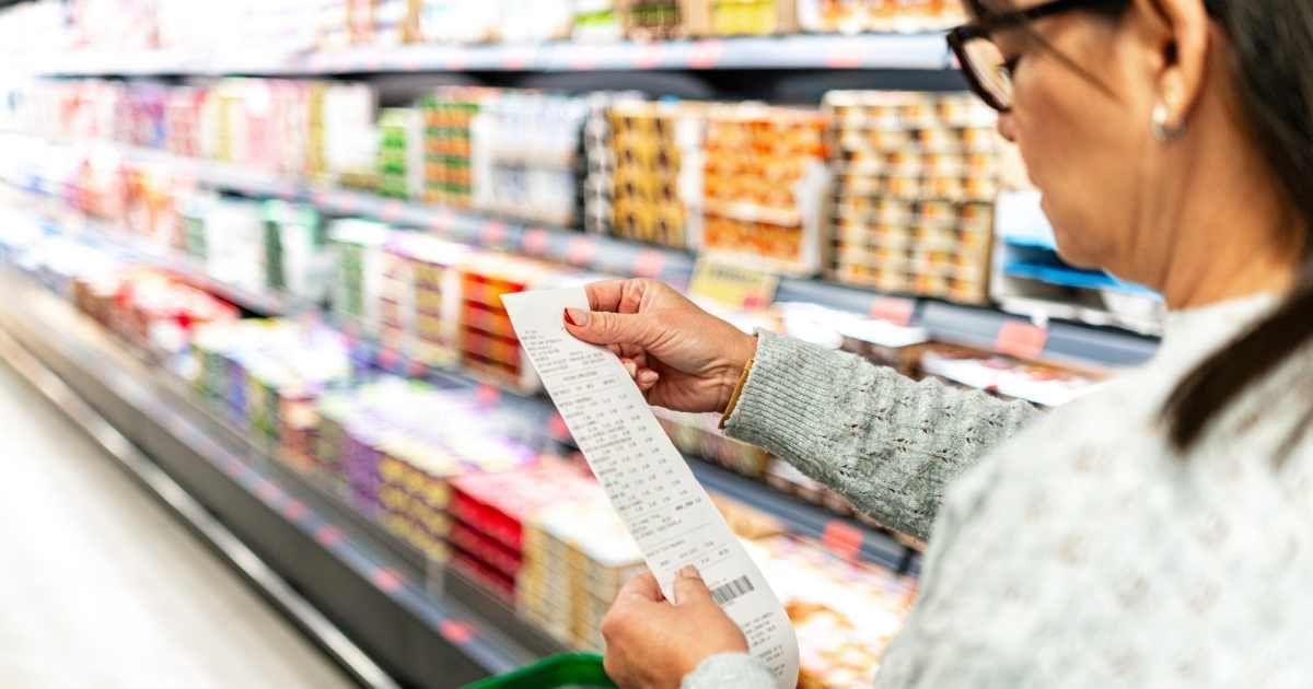 A woman is checking the grocery receipt in a supermarket. (Representative Cover Image Source: Getty Images | FCA Foto Digital)