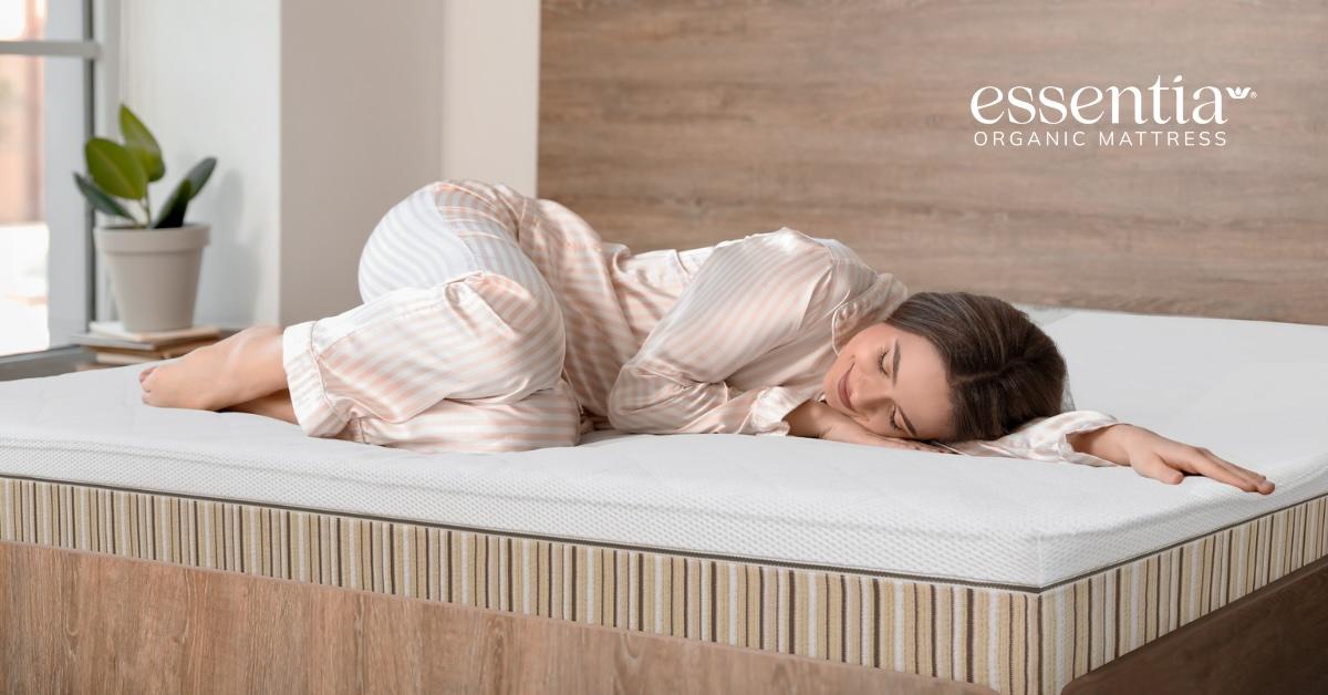 A woman sleeps on an Essentia mattress.