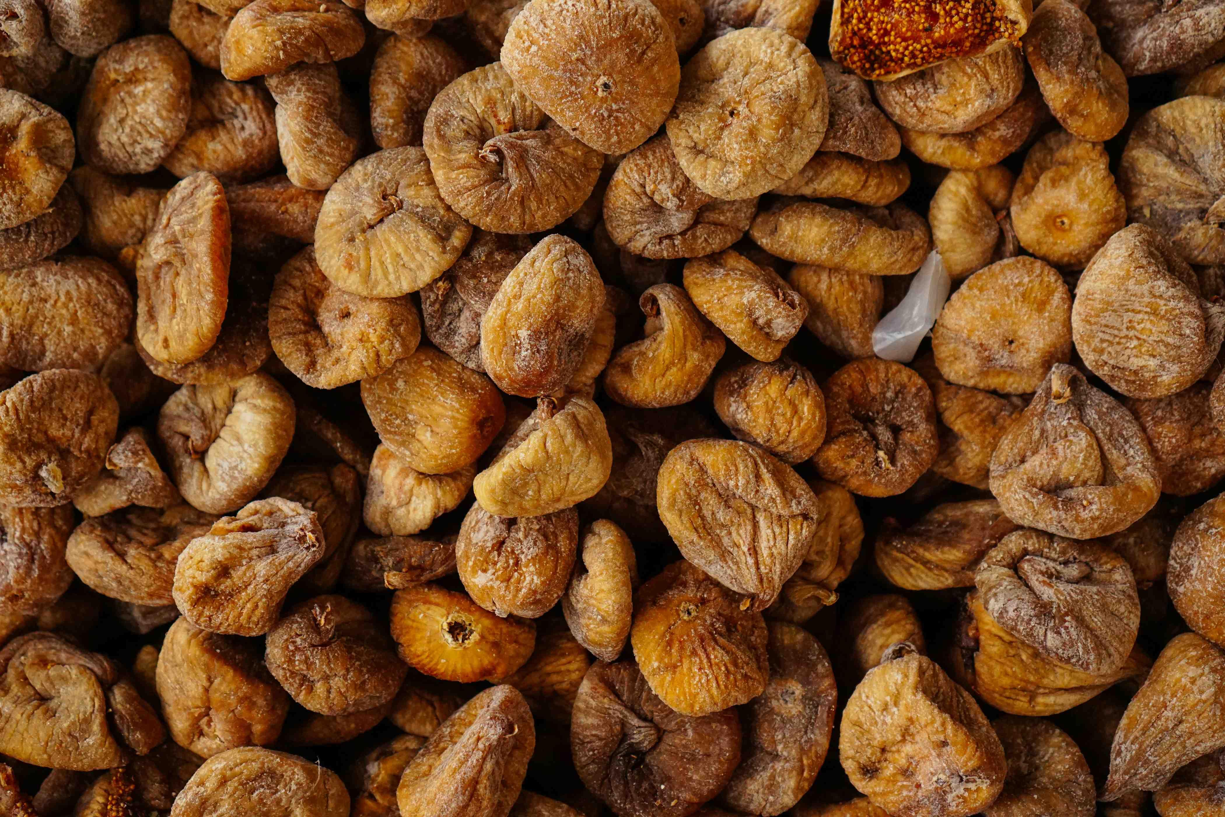 A close-up photo of dried figs stacked atop one another in a Turkish farmers market.