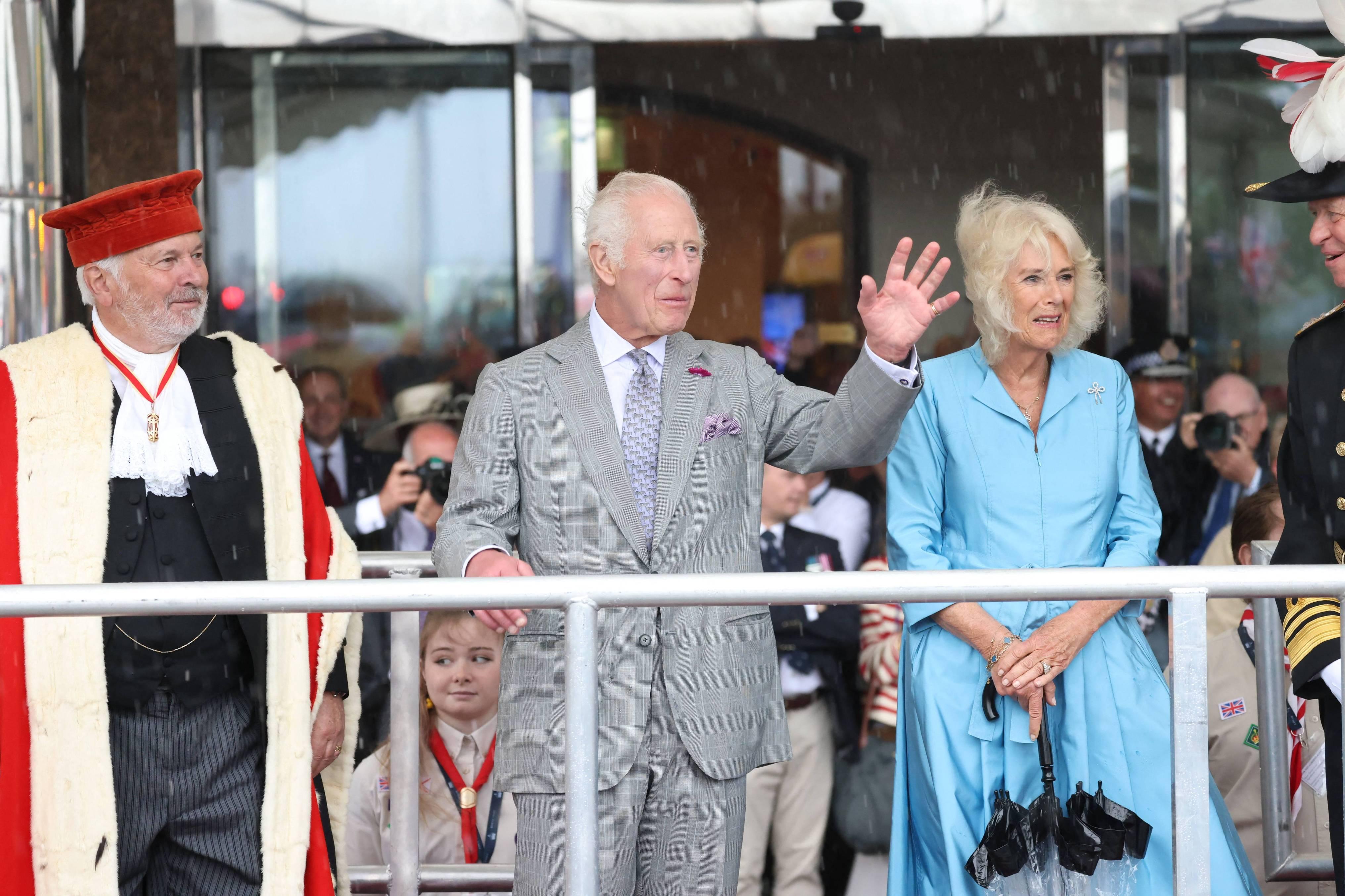 King Charles III and Queen Camilla watch The King's Parade during a visit to Jersey in July 2024.