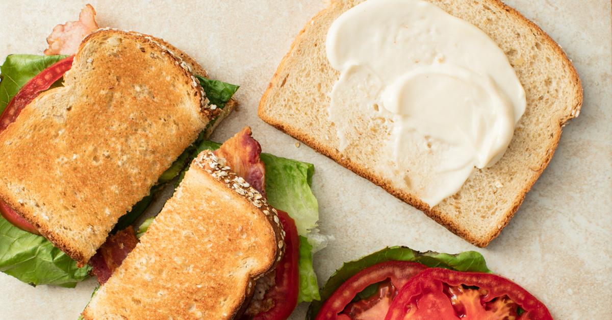 Vegan mayo on a slice of bread for a sandwich