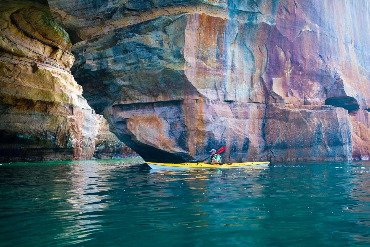 Person kayaking on Lake Superior near Pictured Rocks in Michigan