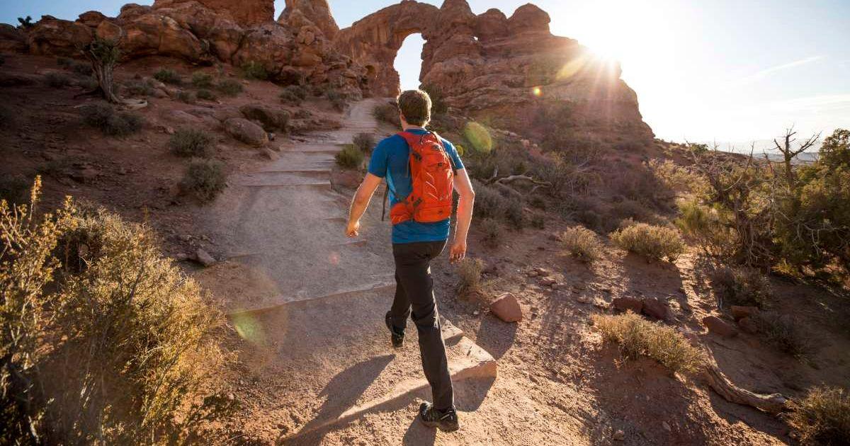 Man hiking in Arches National Park (Representative Cover Image Source: Getty Images | Jordan Siemens)