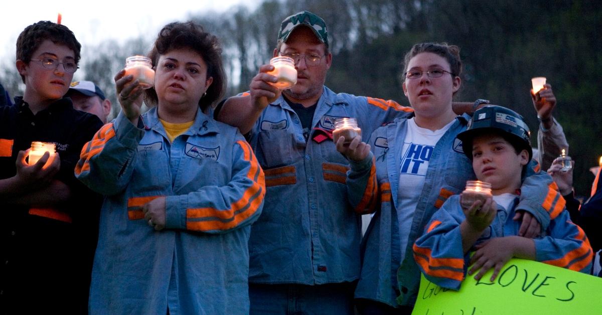 West Virginia residents hold candles in honor of UBB victims. 