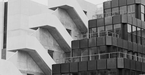 Two eco brutalism style buildings, in black and white
