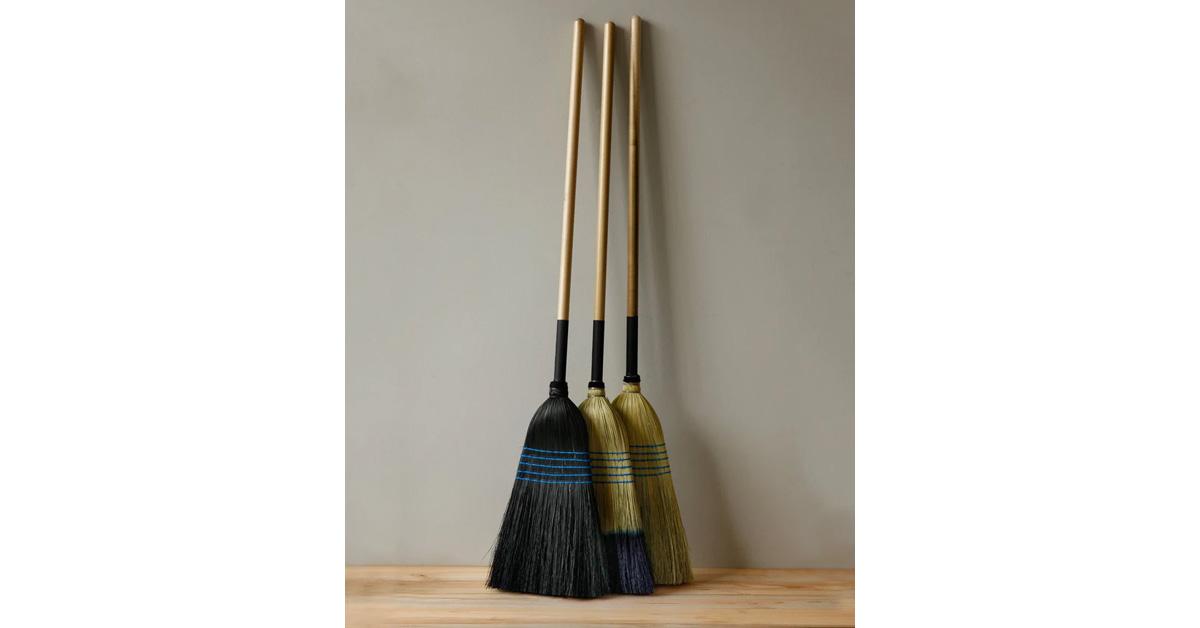 Three brooms in different colors made with corn husk bristles and poplar wood handles