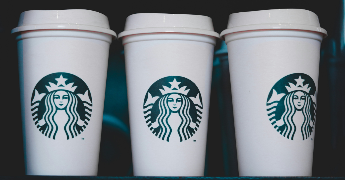 Three Starbucks cups sit on a counter in a row