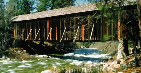 Yosemite's river flowing quickly underneath a covered bridge.